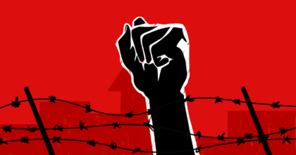 fist raised behind barbwire fence and buildings in the background referencing images of concentration camps
