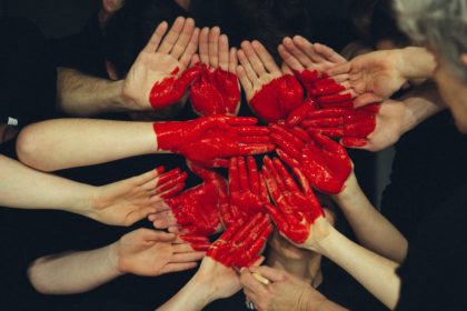 group of hands forming a heart