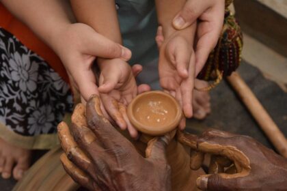 mother helping child make pottery